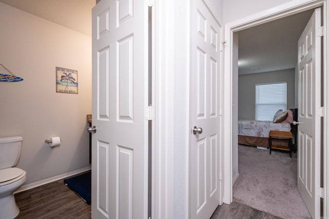 bathroom featuring hardwood / wood-style floors and toilet