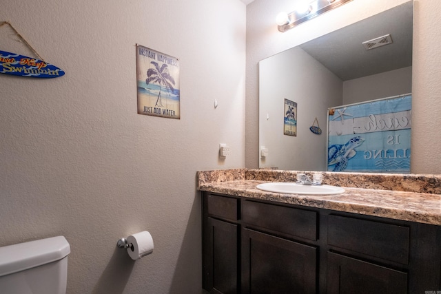 bathroom with vanity and toilet