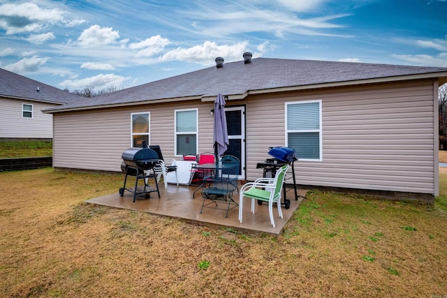 rear view of property featuring a yard and a patio