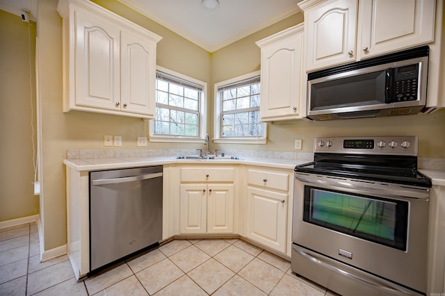 kitchen with crown molding, sink, light tile patterned floors, and appliances with stainless steel finishes