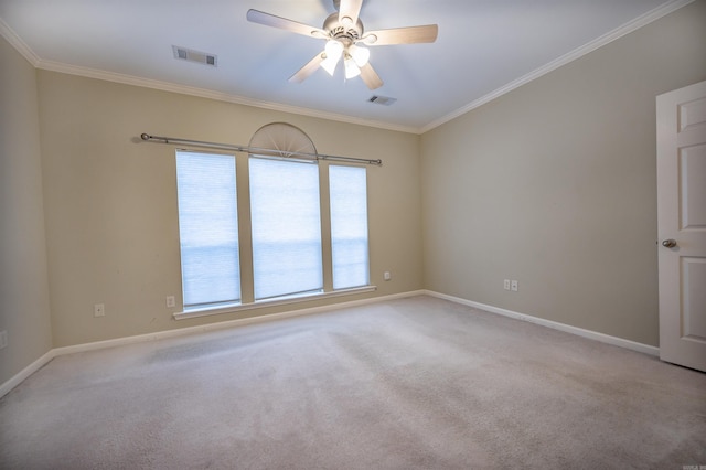 carpeted spare room with ceiling fan and ornamental molding