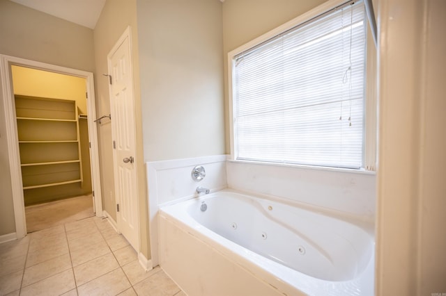 bathroom featuring tile patterned flooring and a tub to relax in