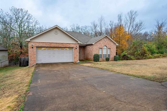 ranch-style home featuring a front lawn and a garage