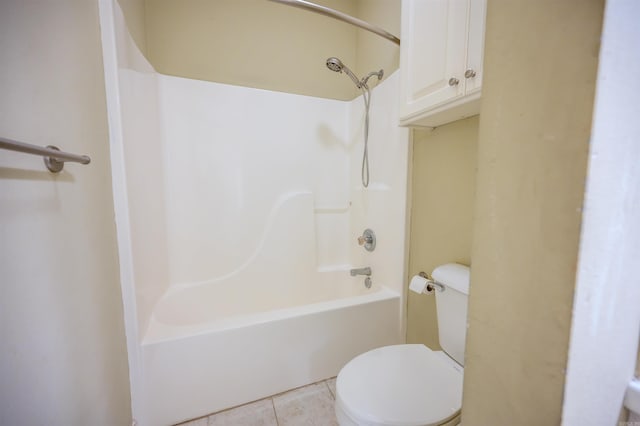 bathroom with shower / washtub combination, tile patterned flooring, and toilet