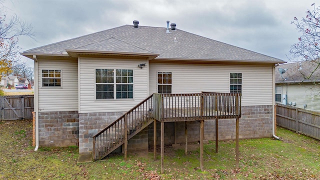 back of property with a wooden deck