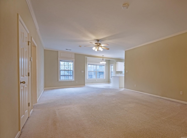 unfurnished room with light carpet, ceiling fan with notable chandelier, and ornamental molding