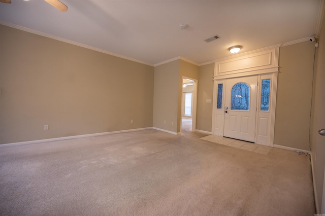 carpeted entrance foyer with ceiling fan and ornamental molding