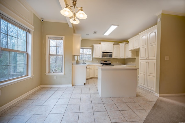 kitchen with white cabinets, light tile patterned floors, decorative light fixtures, stainless steel appliances, and a chandelier