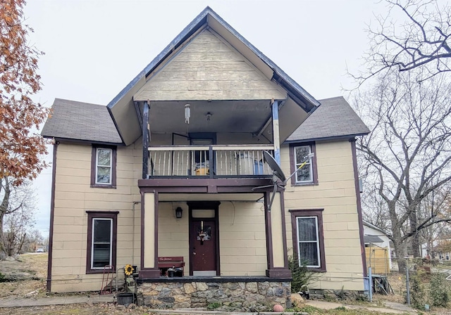 view of front of property featuring covered porch and a balcony