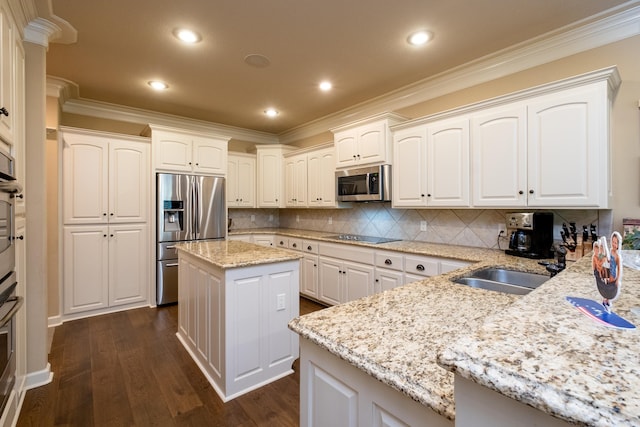 kitchen with dark hardwood / wood-style flooring, light stone countertops, a center island, and appliances with stainless steel finishes