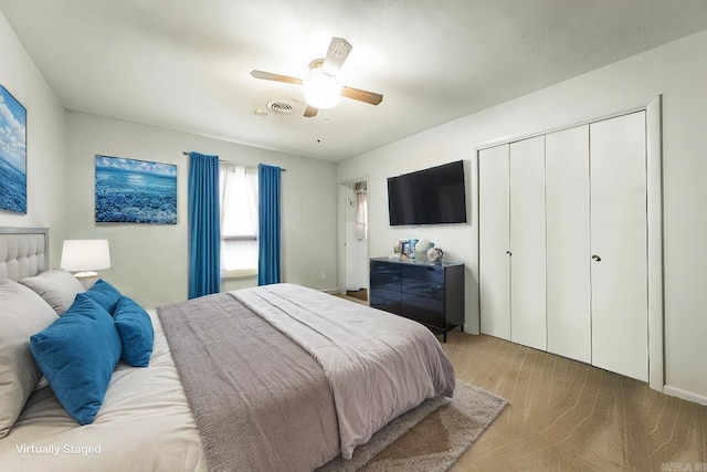 bedroom with ceiling fan and a closet