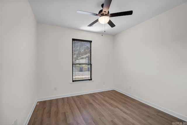 spare room featuring hardwood / wood-style floors and ceiling fan