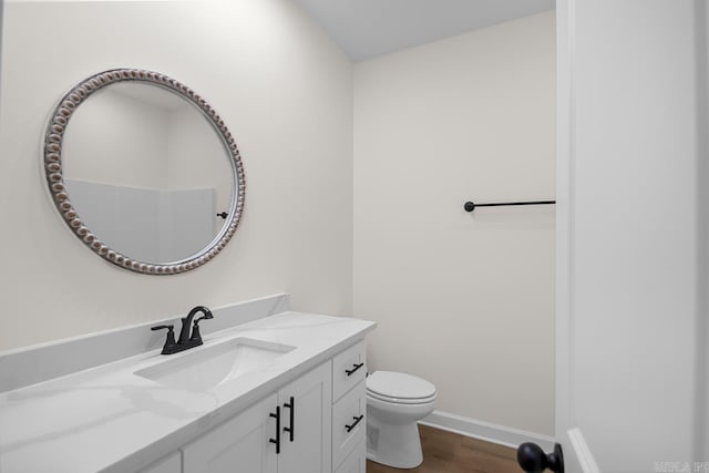 bathroom featuring vanity, toilet, and wood-type flooring