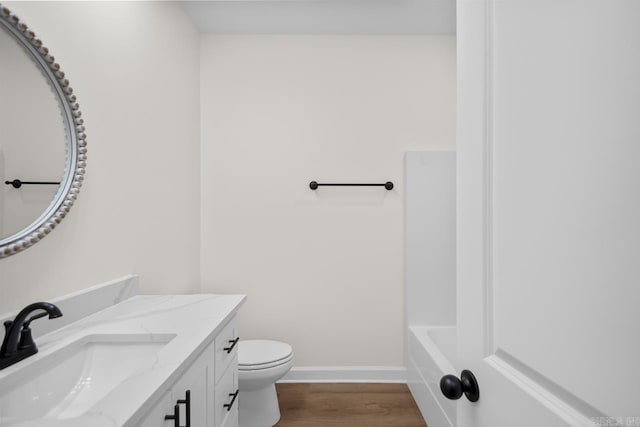 bathroom featuring hardwood / wood-style floors, vanity, and toilet