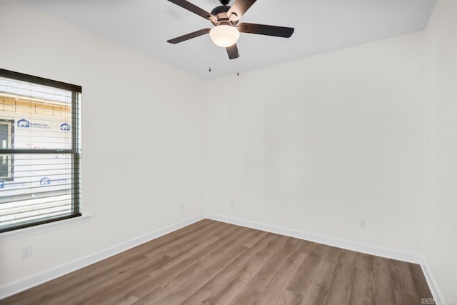 unfurnished room with ceiling fan, a healthy amount of sunlight, and wood-type flooring