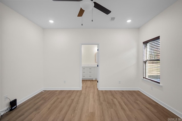 spare room featuring light wood-type flooring and ceiling fan