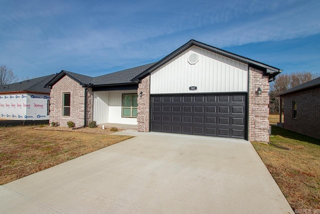 view of front of property with a front yard and a garage