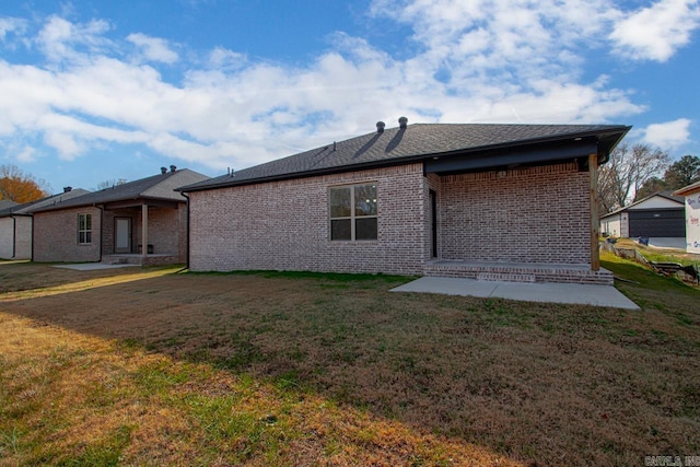 rear view of property with a lawn