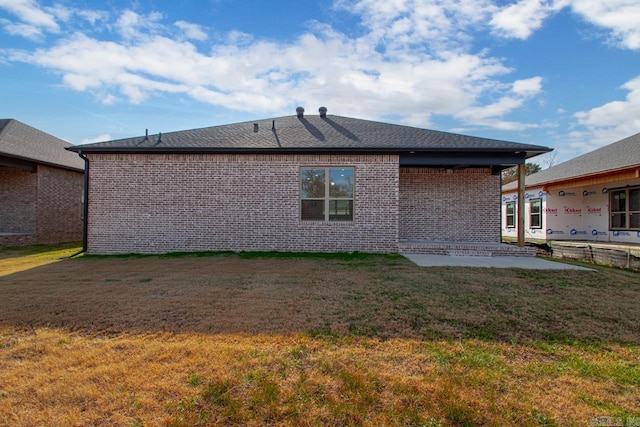 back of house featuring a patio area and a lawn