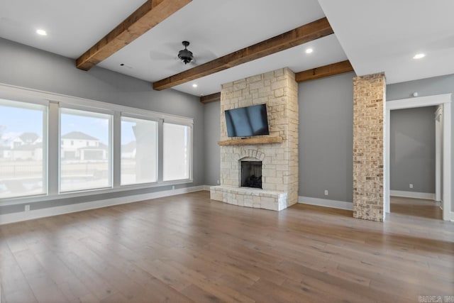 unfurnished living room featuring light wood-type flooring, a wealth of natural light, and ceiling fan