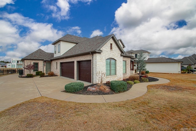 view of property exterior with roof with shingles, a yard, an attached garage, stone siding, and driveway