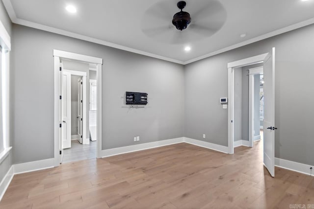 unfurnished room featuring crown molding, ceiling fan, and light hardwood / wood-style floors