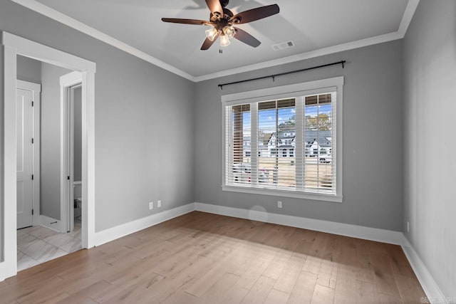 empty room featuring light wood-type flooring, ceiling fan, and crown molding