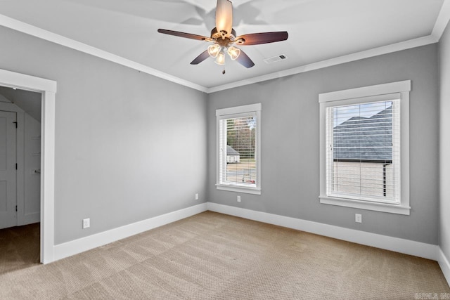 unfurnished room with light carpet, ceiling fan, and ornamental molding