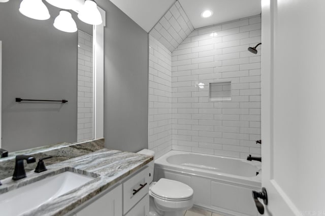 full bathroom with vanity, toilet, and tiled shower / bath combo