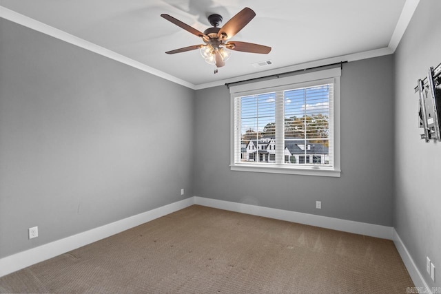 carpeted empty room with ceiling fan and ornamental molding