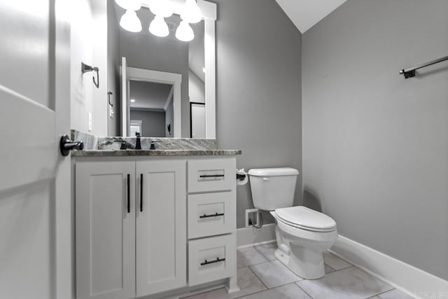 bathroom with tile patterned floors, vanity, lofted ceiling, and toilet