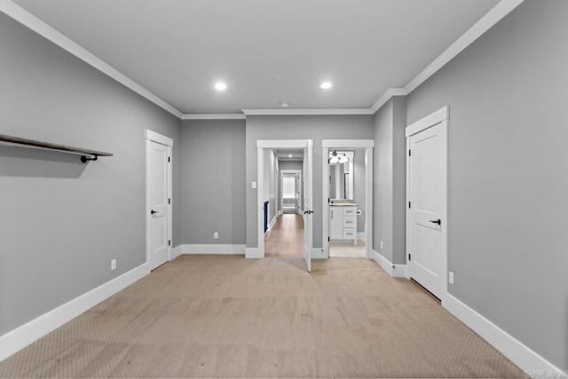 empty room featuring light colored carpet and ornamental molding