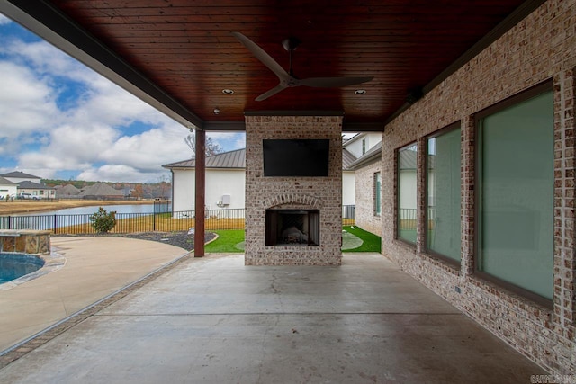 view of patio / terrace featuring an outdoor brick fireplace and ceiling fan