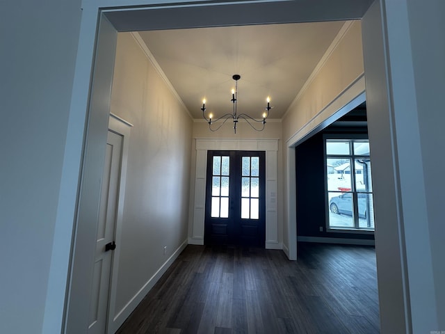 foyer entrance featuring crown molding, a notable chandelier, dark hardwood / wood-style flooring, and french doors