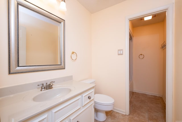 bathroom featuring tile patterned floors, vanity, and toilet