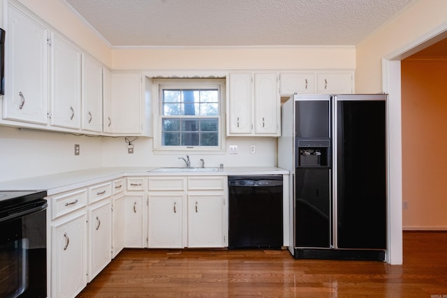 kitchen featuring white cabinetry, sink, dark wood-type flooring, a textured ceiling, and black appliances