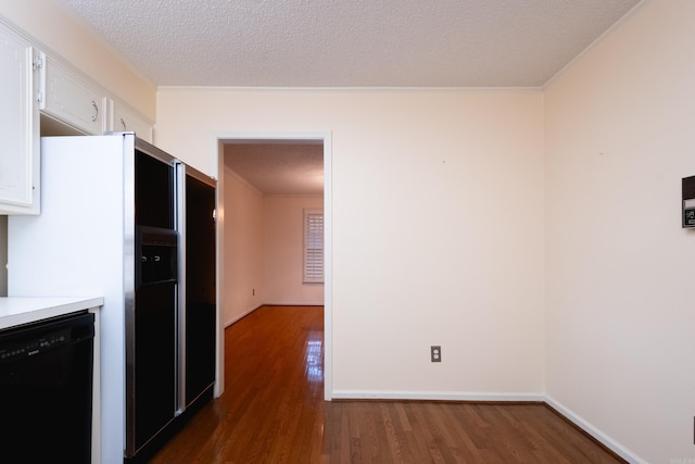 kitchen with dark hardwood / wood-style flooring, white cabinets, a textured ceiling, and black dishwasher