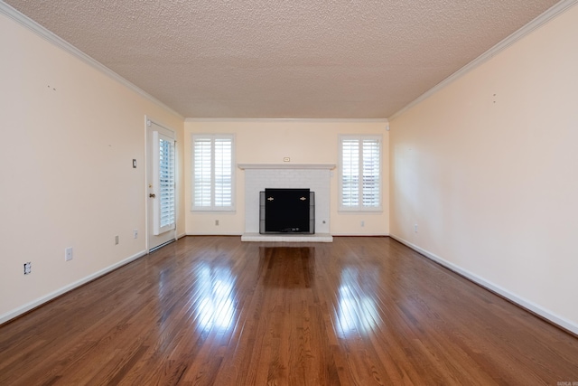 unfurnished living room featuring plenty of natural light, crown molding, wood-type flooring, and a textured ceiling