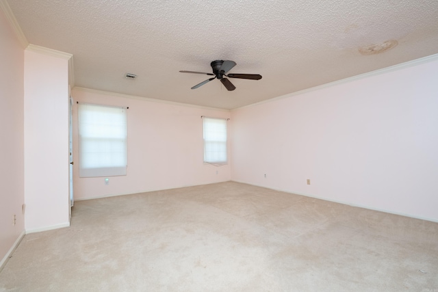 empty room with light colored carpet, a wealth of natural light, crown molding, and ceiling fan