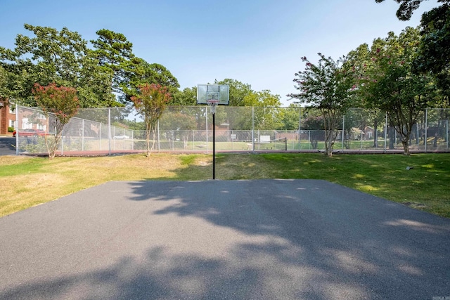 view of sport court with a yard