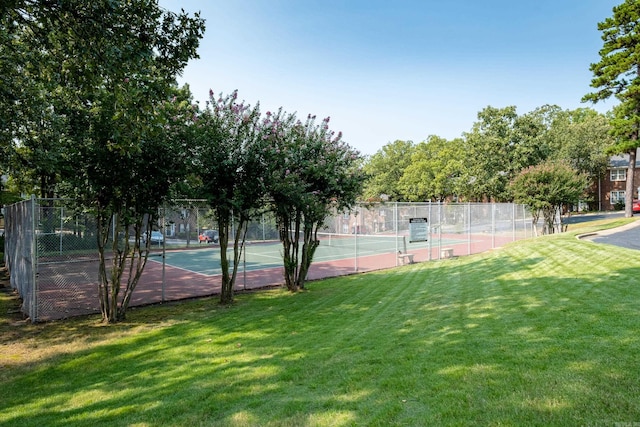 view of tennis court with a lawn