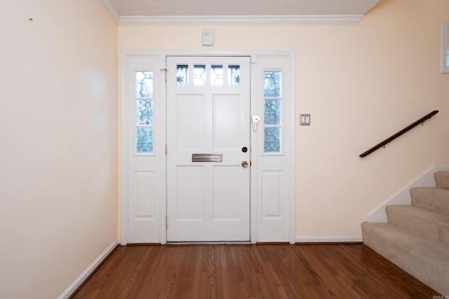 entryway featuring a textured ceiling, dark hardwood / wood-style floors, plenty of natural light, and crown molding