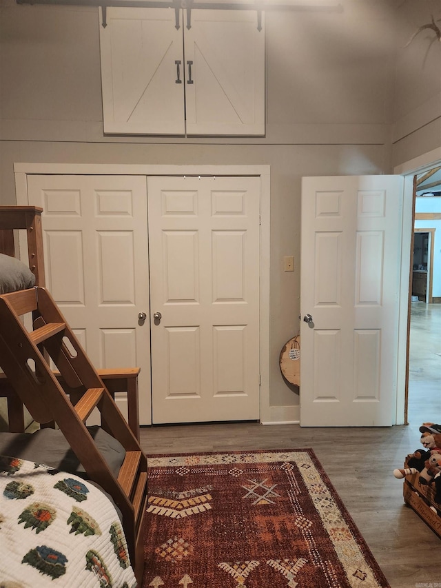 bedroom with hardwood / wood-style flooring and a closet