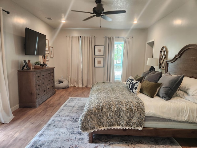 bedroom featuring ceiling fan and hardwood / wood-style flooring