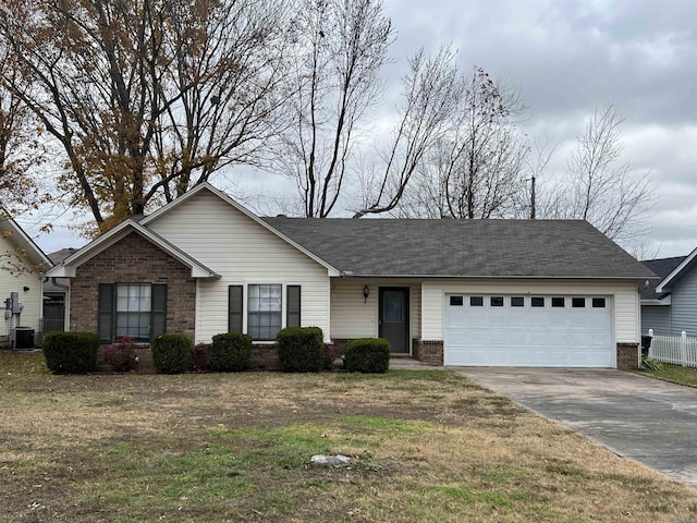 ranch-style home with cooling unit, a garage, and a front lawn