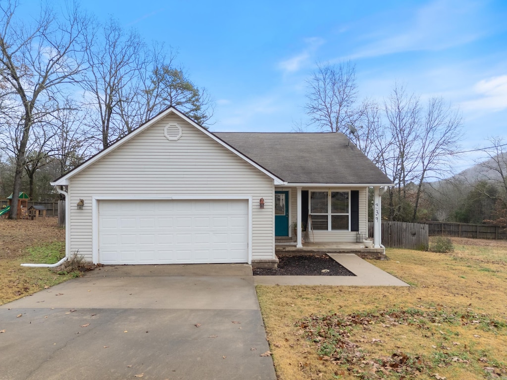 view of front of home featuring a front yard and a garage