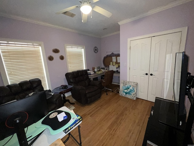 office space featuring crown molding, ceiling fan, and hardwood / wood-style flooring