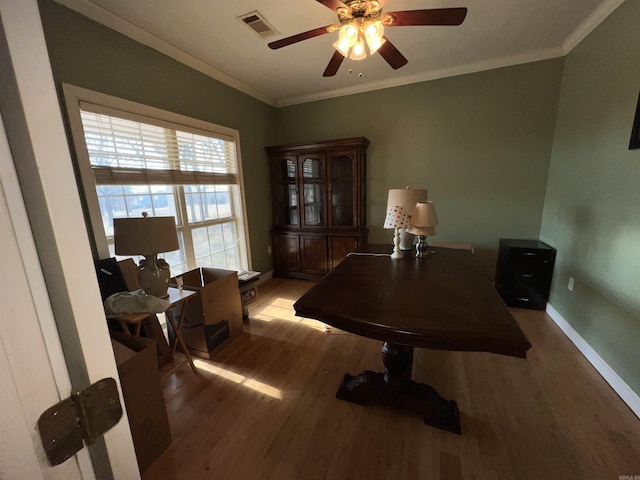 office featuring crown molding, ceiling fan, and dark wood-type flooring