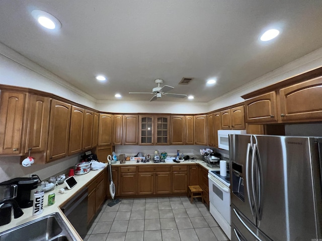 kitchen with white appliances, sink, ceiling fan, light tile patterned floors, and ornamental molding