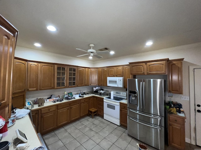 kitchen featuring light tile patterned floors, white appliances, ceiling fan, and ornamental molding